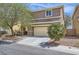 Charming two-story home featuring desert landscaping, attached two car garage, and a welcoming front entrance at 8084 Celina Hills St, Las Vegas, NV 89131
