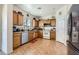 Cozy kitchen featuring wood cabinets, essential appliances, and tile flooring, creating a functional and inviting space at 8084 Celina Hills St, Las Vegas, NV 89131