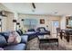 Inviting living room with comfortable seating, a stylish coffee table, and sliding glass doors leading to the outdoors at 8084 Celina Hills St, Las Vegas, NV 89131
