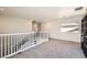Open loft featuring neutral carpet, white railing, and bright window at 8084 Celina Hills St, Las Vegas, NV 89131
