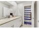 Bright bathroom with a double sink vanity, white cabinets, and a shower with striped curtain at 8351 Gold River Ct, Las Vegas, NV 89113