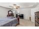 Open second floor bedroom with flat screen tv and dark wood furniture at 8351 Gold River Ct, Las Vegas, NV 89113