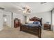 Comfortable bedroom boasts ample natural light, plush carpet, and dark wood furniture at 8351 Gold River Ct, Las Vegas, NV 89113