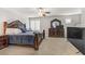 Well lit bedroom featuring dark wood furniture, plantation shutters, and plush carpet at 8351 Gold River Ct, Las Vegas, NV 89113