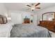 This bedroom contains carpet, a ceiling fan, matching furniture, and closet space at 8351 Gold River Ct, Las Vegas, NV 89113