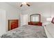 Bright bedroom with light walls, ceiling fan, and dark wood furniture at 8351 Gold River Ct, Las Vegas, NV 89113