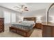 Bedroom featuring a ceiling fan, neutral colored walls, and wood furnishings at 8351 Gold River Ct, Las Vegas, NV 89113