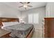 Comfortable bedroom features a ceiling fan, and large window with plantation shutters at 8351 Gold River Ct, Las Vegas, NV 89113