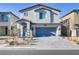Charming two-story home with a gray tiled roof and a matching gray two-car garage door at 8351 Gold River Ct, Las Vegas, NV 89113