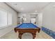Bright game room with pool table and natural light from the shuttered windows at 8351 Gold River Ct, Las Vegas, NV 89113