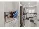 Modern kitchen with stainless steel appliances, granite countertops, and white cabinets at 8351 Gold River Ct, Las Vegas, NV 89113