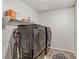 The laundry room features a modern washer, dryer, and shelving at 8351 Gold River Ct, Las Vegas, NV 89113