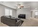 Relaxing second floor living room features a modern couch and large flat screen TV at 8351 Gold River Ct, Las Vegas, NV 89113