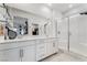 Bright, modern bathroom with double vanity, glass-enclosed shower, and marble floors at 892 Elmwood Forest Ln, Las Vegas, NV 89138