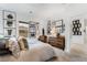 Bright bedroom featuring unique wall decor and herringbone floors leading to doorway at 892 Elmwood Forest Ln, Las Vegas, NV 89138