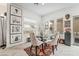 Elegant dining area with a glass table and tufted chairs, perfect for entertaining at 892 Elmwood Forest Ln, Las Vegas, NV 89138