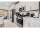 Modern kitchen features stainless steel appliances and white cabinetry at 892 Elmwood Forest Ln, Las Vegas, NV 89138