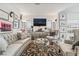 Cozy living room featuring stylish decor and a large flat-screen TV at 892 Elmwood Forest Ln, Las Vegas, NV 89138