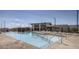 Resort-style pool with a modern clubhouse and desert landscape views offers a luxurious experience at 892 Elmwood Forest Ln, Las Vegas, NV 89138