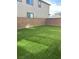 Large backyard area with artificial grass and privacy wall, great for entertaining at 9159 Oxford Blue Ave, Las Vegas, NV 89148