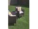 Cozy backyard seating area with artificial grass and colorful pillows at 9159 Oxford Blue Ave, Las Vegas, NV 89148