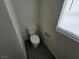 Powder room with neutral walls, wood-look flooring, and a window at 9159 Oxford Blue Ave, Las Vegas, NV 89148