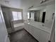 Bright bathroom showcasing a double sink vanity, granite countertops, and a shower-tub combo at 9159 Oxford Blue Ave, Las Vegas, NV 89148