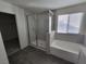 Stylish bathroom featuring a glass-enclosed shower, soaking tub, and neutral finishes at 9159 Oxford Blue Ave, Las Vegas, NV 89148
