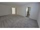 Neutral bedroom featuring soft carpet, white walls, and open bathroom access at 9159 Oxford Blue Ave, Las Vegas, NV 89148