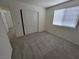 This bedroom features neutral walls, carpet, a window, and a closet with folding doors at 9159 Oxford Blue Ave, Las Vegas, NV 89148