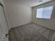 This bedroom features neutral walls, carpet, and a window at 9159 Oxford Blue Ave, Las Vegas, NV 89148