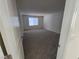 Spacious bedroom with neutral walls, carpet, and a window providing natural light at 9159 Oxford Blue Ave, Las Vegas, NV 89148