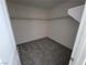 Walk-in closet with carpet flooring and ample shelving, ready for organization at 9159 Oxford Blue Ave, Las Vegas, NV 89148