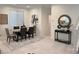 Dining room with a modern table and chairs, complemented by elegant decor and tile flooring at 9159 Oxford Blue Ave, Las Vegas, NV 89148