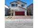 Inviting two-story home with a red garage door and a well-manicured front yard at 9159 Oxford Blue Ave, Las Vegas, NV 89148