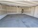 View of the garage with cement flooring and off-white walls at 9159 Oxford Blue Ave, Las Vegas, NV 89148