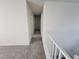 Upstairs hallway with soft carpet flooring and white banister leading to bedrooms at 9159 Oxford Blue Ave, Las Vegas, NV 89148