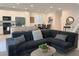 Open concept living room and kitchen with modern decor and a spacious seating area at 9159 Oxford Blue Ave, Las Vegas, NV 89148