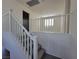 Carpeted stairs lead to an upstairs landing with white railings at 9159 Oxford Blue Ave, Las Vegas, NV 89148