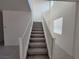 Carpeted staircase with white railings leading to the upper level at 9159 Oxford Blue Ave, Las Vegas, NV 89148