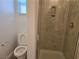 Modern bathroom featuring a glass-enclosed shower and a low-flow toilet at 9463 Jumping Frog Ct, Las Vegas, NV 89147