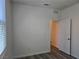 A bright bedroom features wood-look floors, white walls and an access door at 9463 Jumping Frog Ct, Las Vegas, NV 89147