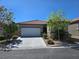Charming single-story home featuring a tile roof, stone accents, and a well-maintained front yard at 9463 Jumping Frog Ct, Las Vegas, NV 89147
