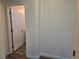 Hallway with wood-look flooring, leading to a bedroom with a bathroom at 9463 Jumping Frog Ct, Las Vegas, NV 89147