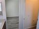 Hallway with wood-look floors leading to a powder room featuring neutral colors at 9463 Jumping Frog Ct, Las Vegas, NV 89147