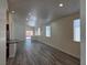 Spacious living room with an open floor plan, recessed lighting, and light gray wood-look floors at 9463 Jumping Frog Ct, Las Vegas, NV 89147