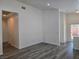 View of the bright living room with wood-look floors and ample natural light at 9463 Jumping Frog Ct, Las Vegas, NV 89147