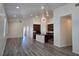 Well-lit open floor plan kitchen and living area with hardwood floors at 9463 Jumping Frog Ct, Las Vegas, NV 89147