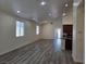 Open living room with wood-look flooring, recessed lighting, and kitchen view at 9463 Jumping Frog Ct, Las Vegas, NV 89147