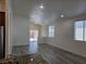 Bright living room with recessed lighting, wood-look floors and sliding glass door to the backyard at 9463 Jumping Frog Ct, Las Vegas, NV 89147